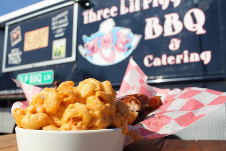 Three Little Piggies BBQ homemade mac and cheese and ribs with food truck behind